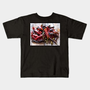 Dried chili peppers on a wooden board Kids T-Shirt